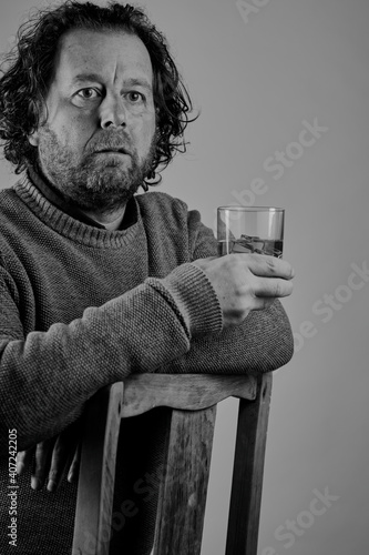 Portrait of a attractive bearded man drinking whisky. photo