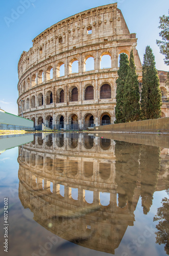 Rome, Italy - in Winter time, frequent rain showers create pools in which the wonderful Old Town of Rome reflect like in a mirror. Here in particular the Colosseum