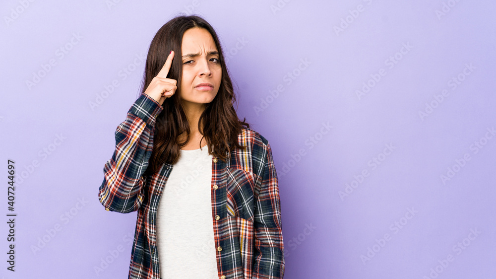 Young mixed race hispanic woman isolated pointing temple with finger, thinking, focused on a task.