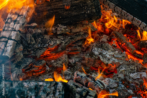 Burning coals at night, rotting coal, barbecue season. Close-up.