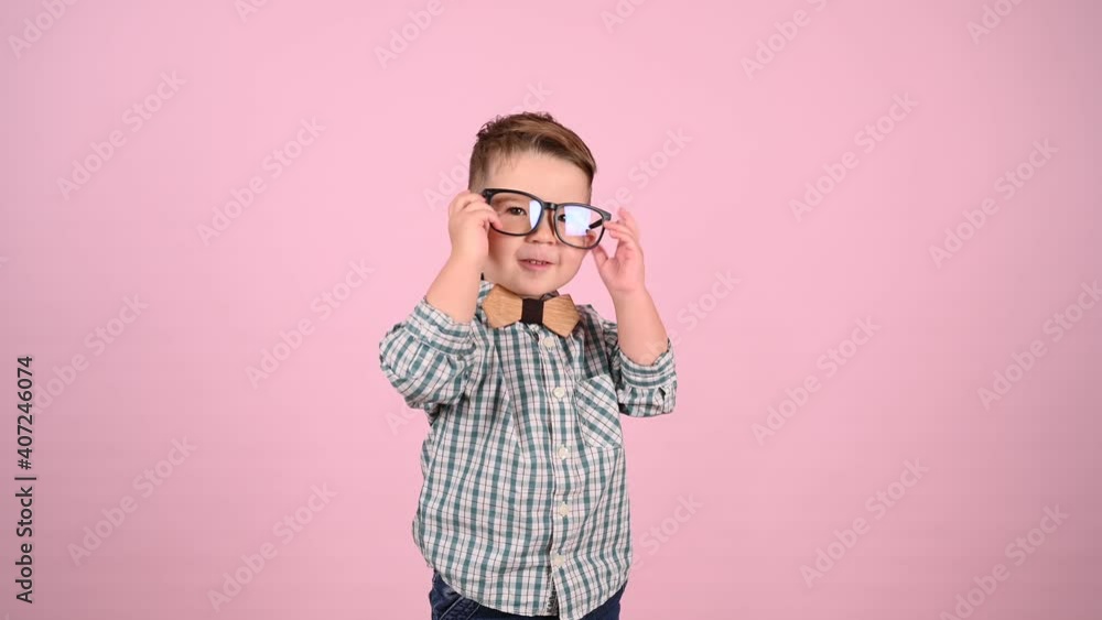 child with glasses, on a pink background. High quality video child with glasses, on a pink background. High quality video