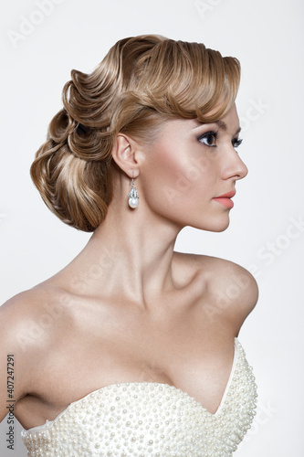 Beautiful bride with fashion wedding hairstyle - on white, retro style background.