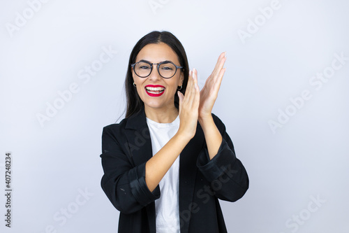 Beautiful business woman clapping and applauding happy and joyful, smiling proud hands together photo