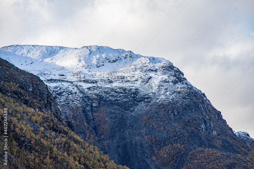 Yellow valley with snow mountains on the side near Skibotn in Norway