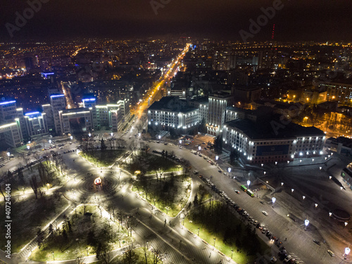 Aerial night view on Freedom Svobody Square in illumination lights circus. Derzhprom and Karazina National University in Kharkiv city center, Ukraine