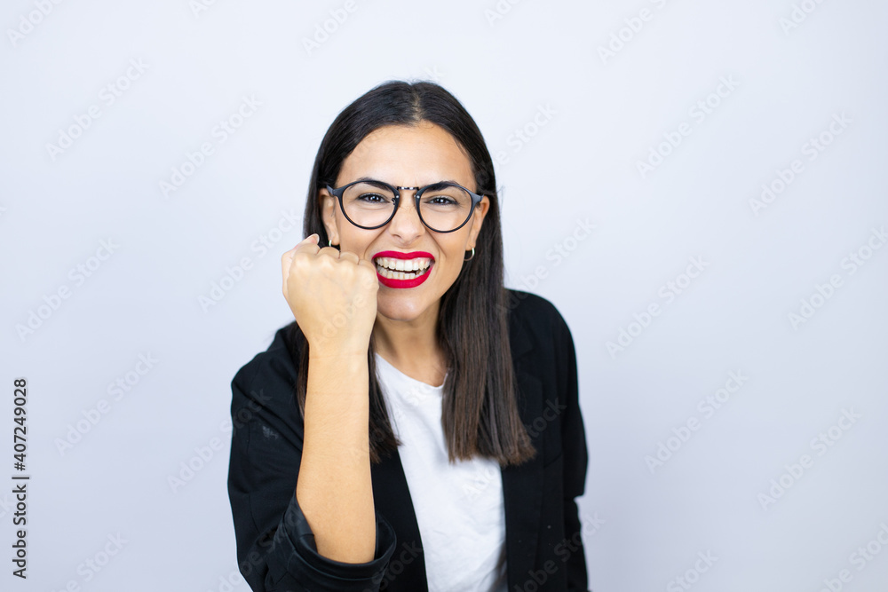 Beautiful business woman angry and mad raising fist frustrated and furious while shouting with anger. Rage and aggressive concept. Beautiful business woman angry and mad raising fist frustrated and furious while shouting with anger. Rage and aggressive concept.