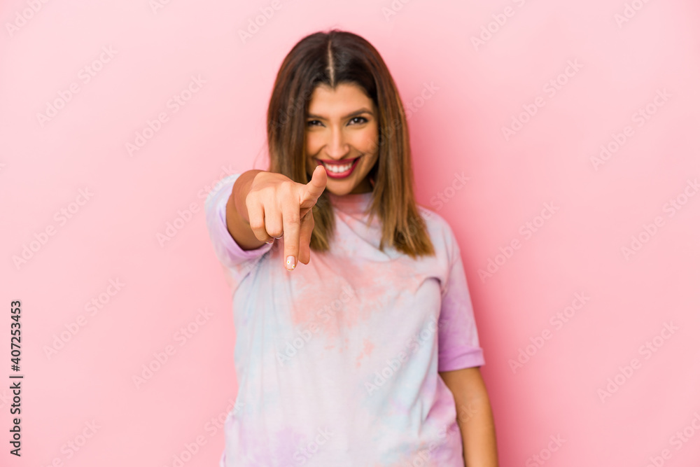 Young indian woman isolated on pink background cheerful smiles pointing to front. Young indian woman isolated on pink background cheerful smiles pointing to front.