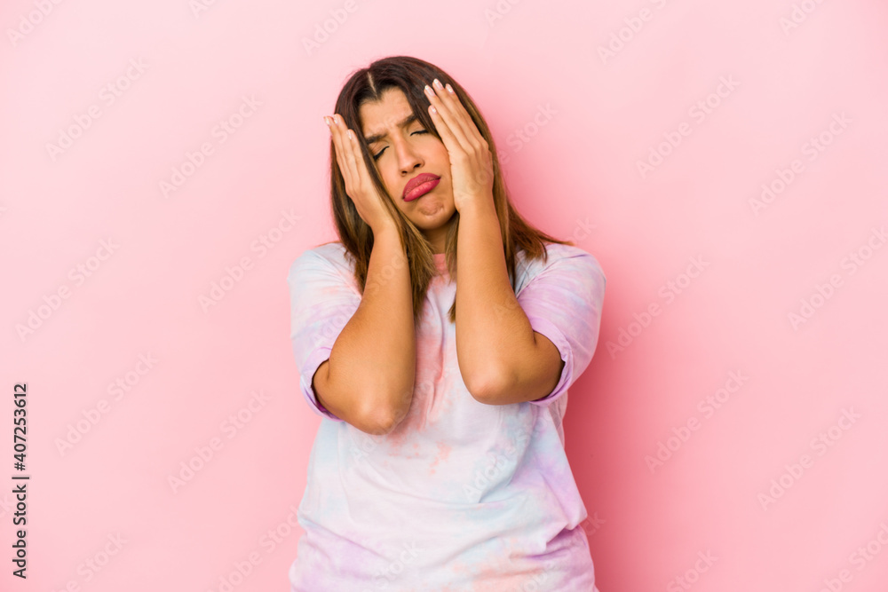 Young indian woman isolated on pink background whining and crying disconsolately.