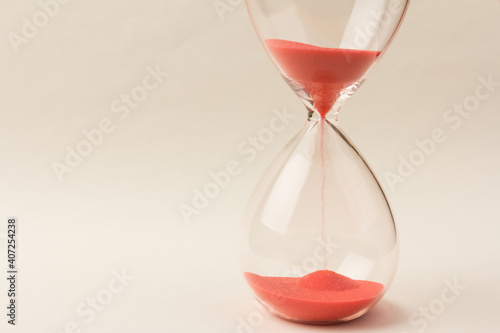 Crystal hourglass on champagne background as a concept of passing time for business term, urgency and outcome of time.