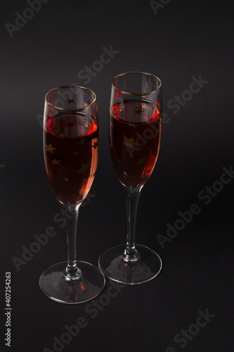 Two Champagne glasses on the black background. Composition for Valentine's day