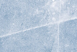 Frozen lake ice texture background. Textured cold frosty surface of ice with cracks.
