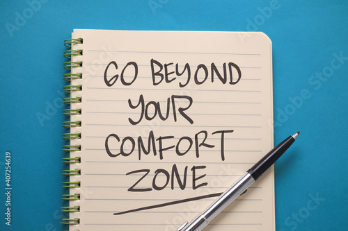 Wallpaper Mural Go beyond your comfort zone, text words typography written on book against blue background, life and business motivational inspirational Torontodigital.ca