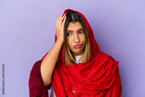 Young indian woman wearing a hijab isolated being shocked, she has remembered important meeting. © Asier
