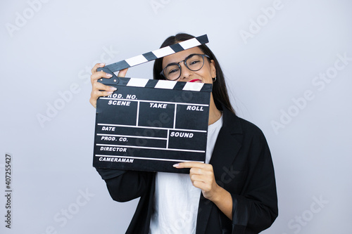 Beautiful business woman holding a clapperboard