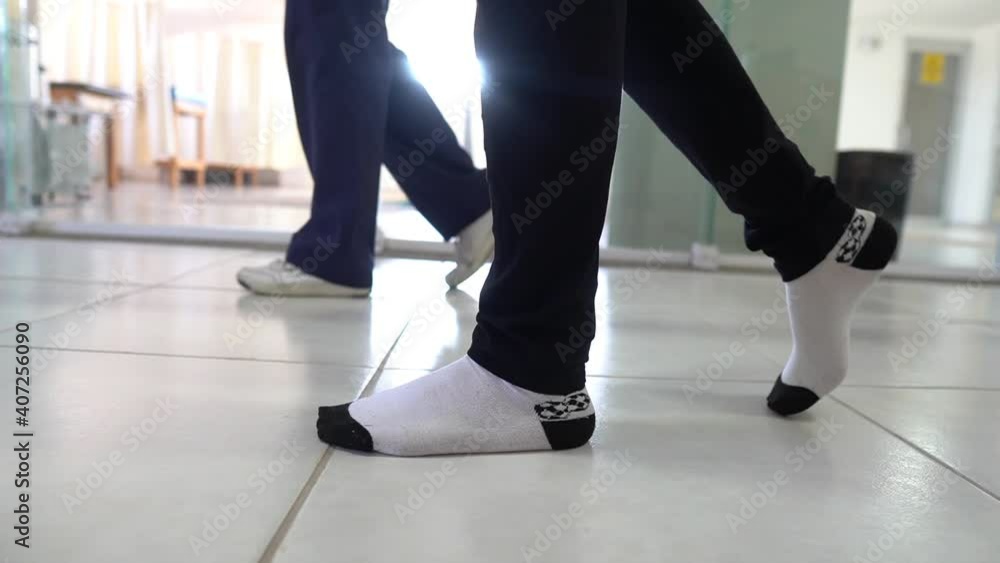 Athletic patient walking in parallel bars Athletic patient walking in parallel bars