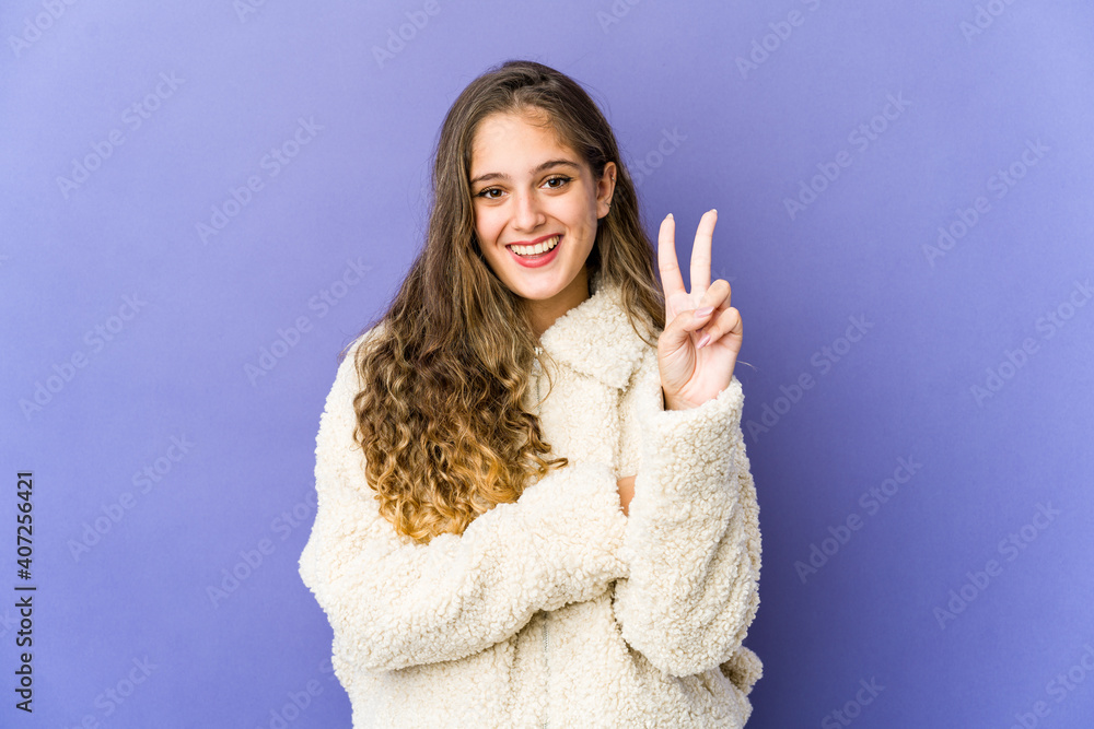 Young caucasian cute woman showing number two with fingers. Young caucasian cute woman showing number two with fingers.