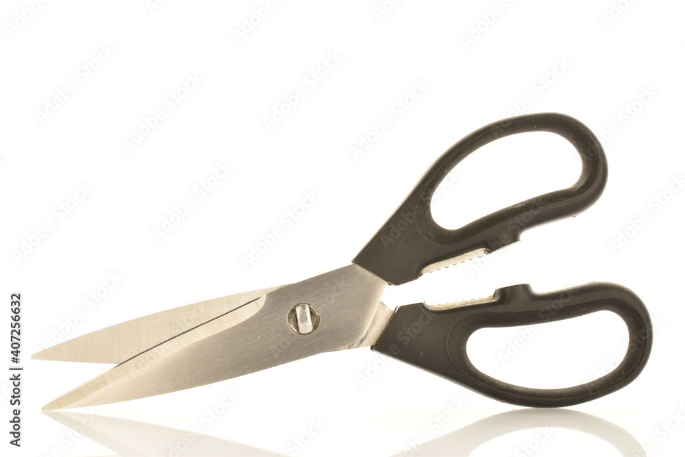 One metal scissors with black plastic handles, for the kitchen, close-up, isolated on white. One metal scissors with black plastic handles, for the kitchen, close-up, isolated on white.