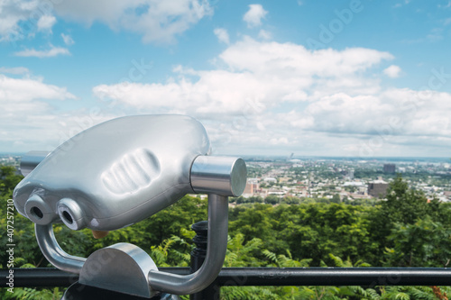 Close-up of some binoculars with the city of Montreal in the background