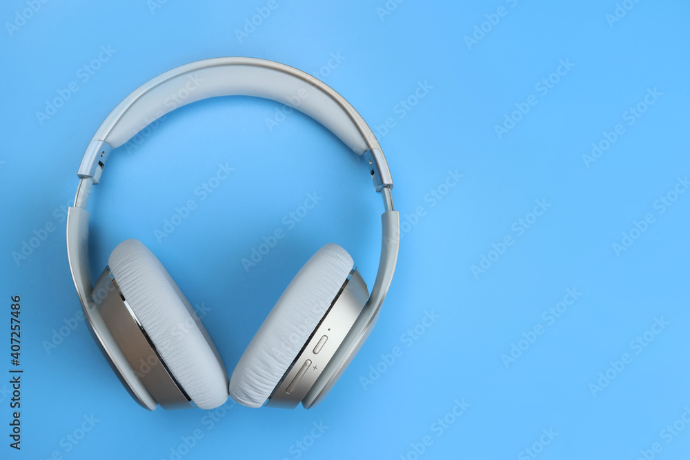 Full-size wireless overhead headphones on blue background Full-size wireless overhead headphones on blue background