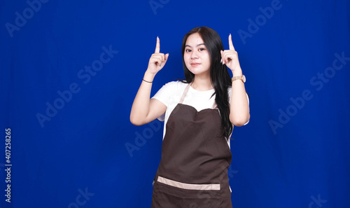 asian shopkeeper woman pointing blank space