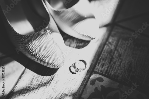 Beautiful toned picture with wedding rings and wedding shoes