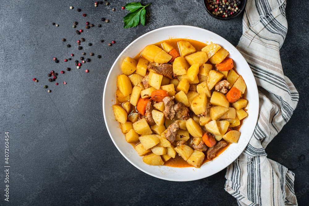 Fototapeta premium goulash meat with potatoes stewed vegetables and pork on the table for healthy meal snack outdoor top view copy space for text food background rustic image