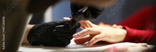 The manicurist processes the cuticles in the salon or at home during quarantine. Standard set for creating manicure