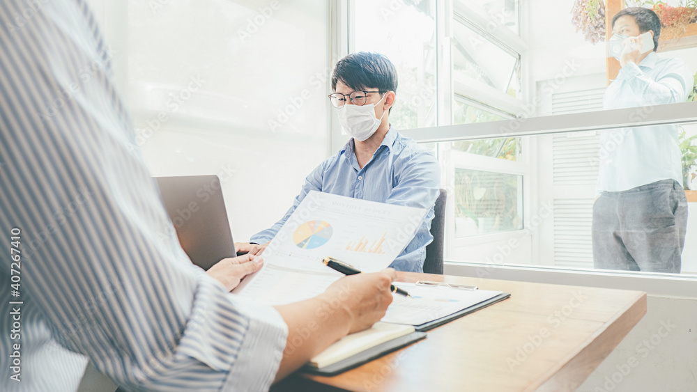 Asian People Successful Teamwork Business Wearing Medical Mask and Working. Work from Private Office Social Distancing among Coronavirus Outbreak Situation