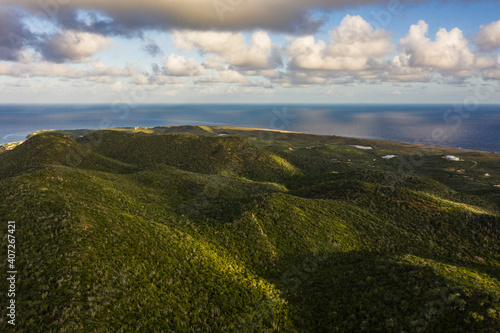 Aerial view above scenery of Curacao, Caribbean with ocean, coast, hills, lake