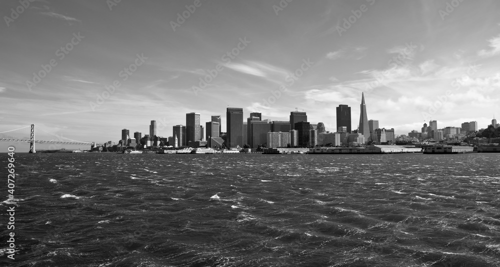 Black and white panoramic view of San Francisco towers with choppy wind blown waves.