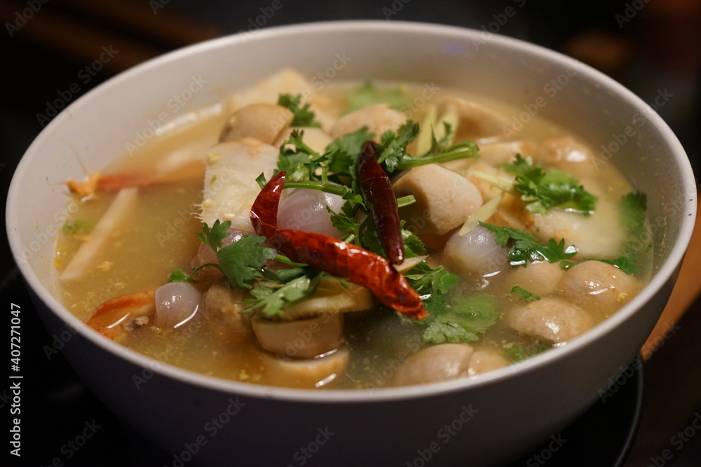 Tom Yam Kung Soup in white bowl at fish market and food stall in Bangkok, Thailand Tom Yam Kung Soup in white bowl at fish market and food stall in Bangkok, Thailand