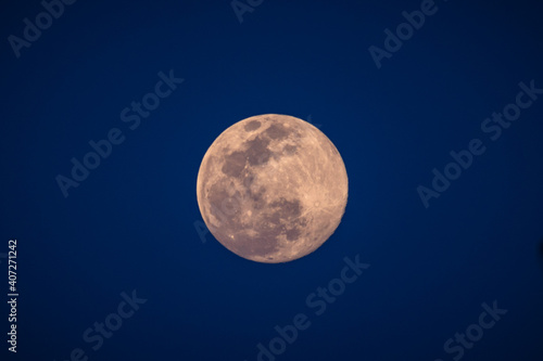 A supermoon is a full moon that nearly coincides with perigee, the closest that the Moon comes to the Earth in its elliptic orbit resulting in a slightly larger-than-usual apparent size of lunar disk. photo