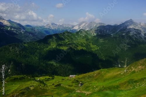 gorgeous mounain landscape with green hills and a alpine hut