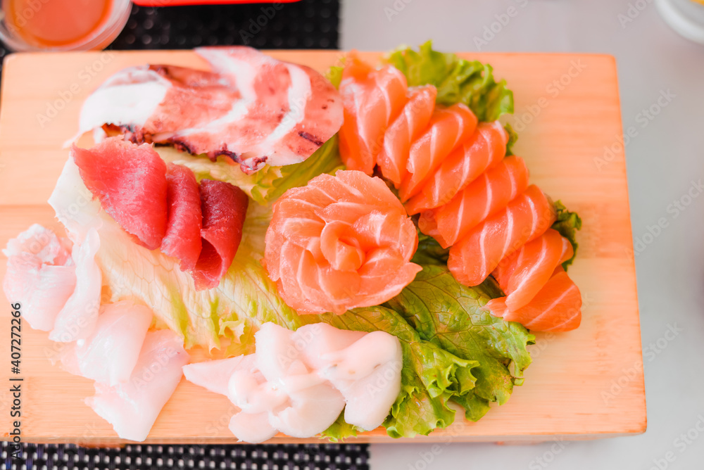 Japan of raw fresh fish fillet, sashimi mix salmon and tuna set on wooden board