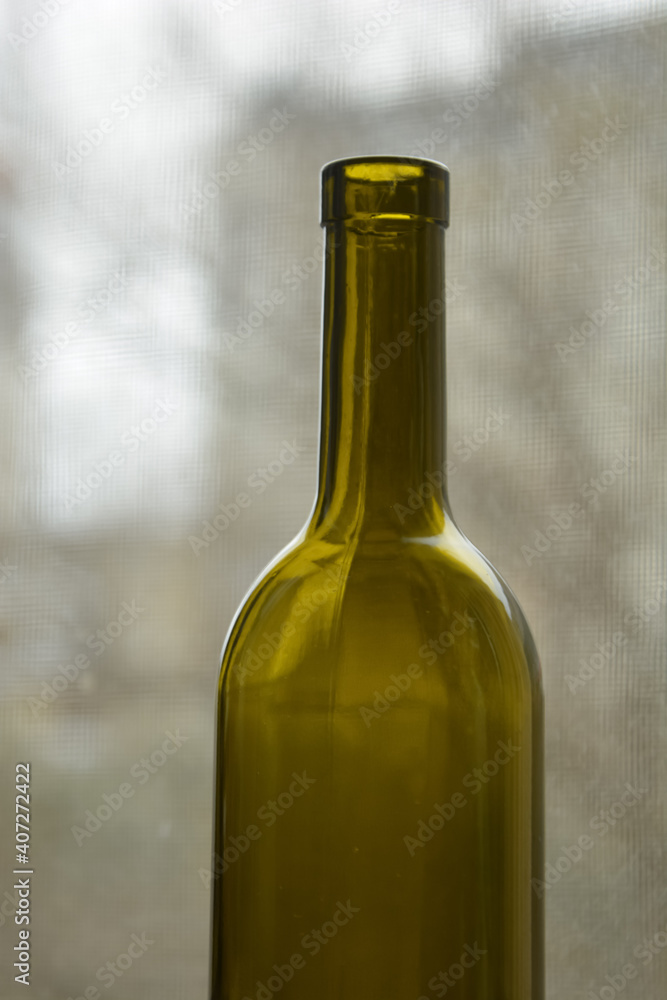 A green bottle for wine and delicious tangerines.
