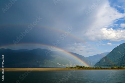 Beautiful double rainbow above Teletskoe lake after heavy rain.
