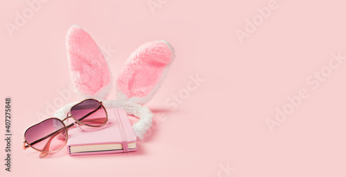 Pink girlie fluffy bunny ears with notepad and sunglasses on pink banner. Happy Valentines day greeting card or fancy dress invitation. Hen party. Copy space