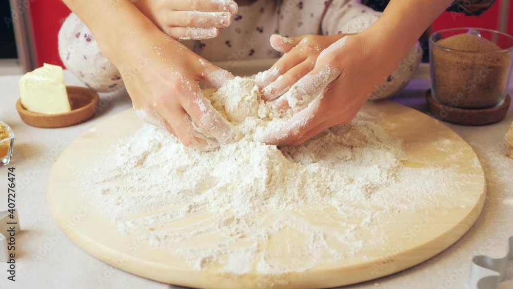 The view from the top: Mother and daughter preparing dough for Christmas holiday ginger cookies. children prepare homemade cakes. The view from the top: Mother and daughter preparing dough for Christmas holiday ginger cookies. children prepare homemade cakes.