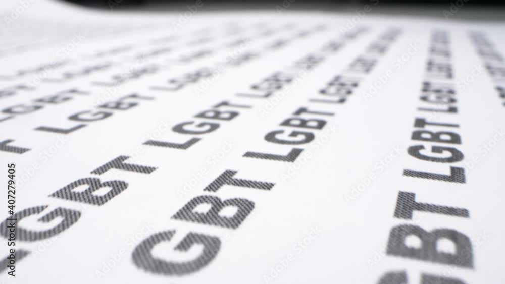 background text. extremely close-up, detailed. abbreviation LGBT written on a white piece of paper many times