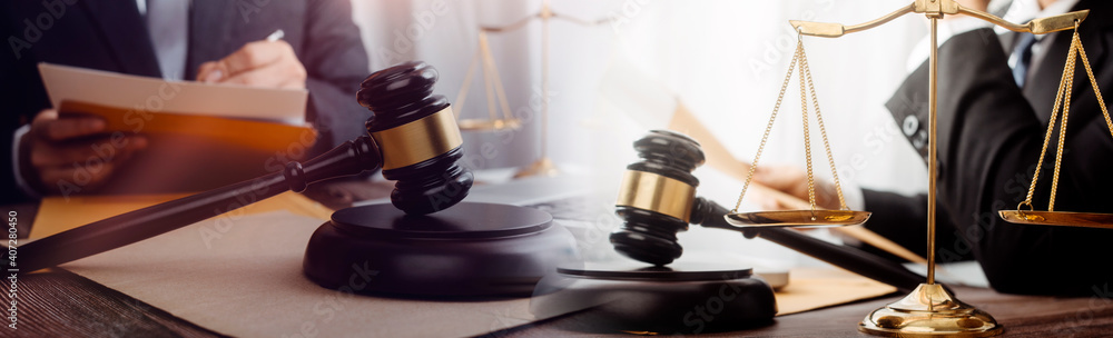 Business and lawyers discussing contract papers with brass scale on desk in office. Law, legal services, advice, justice and law concept .
Business and lawyers discussing contract papers with brass scale on desk in office. Law, legal services, advice, justice and law concept .