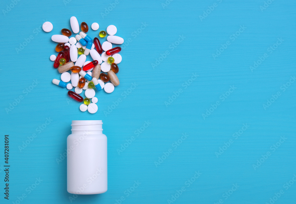 Colorful pills and tablets on blue Colorful pills and tablets on blue
