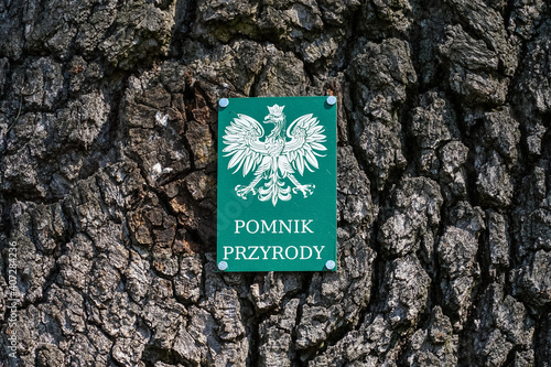 Natural monument sign on an old tree, Poland