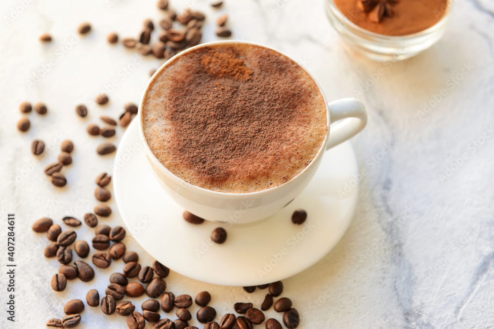 Tasty coffee with cinnamon in cup on light background Tasty coffee with cinnamon in cup on light background