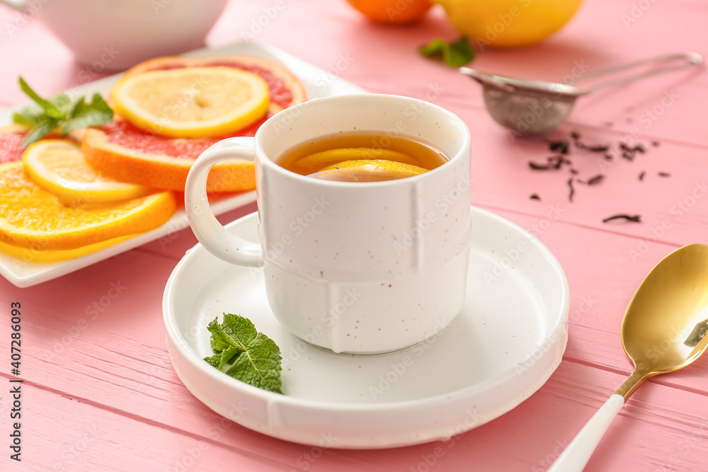 Cup of hot tea with lemon and grapefruit on wooden background Cup of hot tea with lemon and grapefruit on wooden background