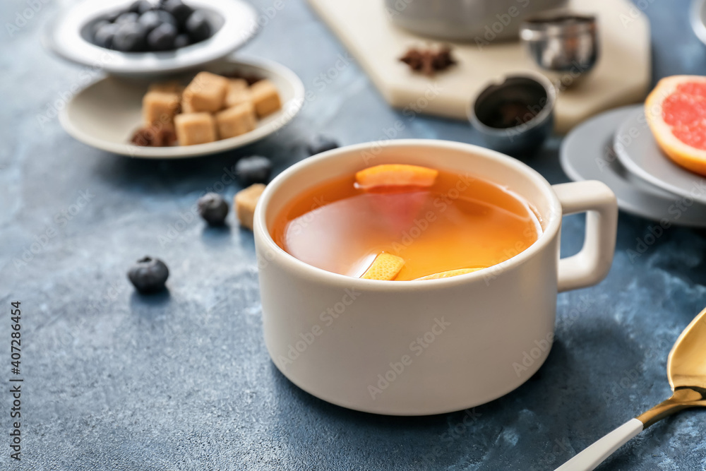 Cup of hot tea with grapefruit on color background Cup of hot tea with grapefruit on color background