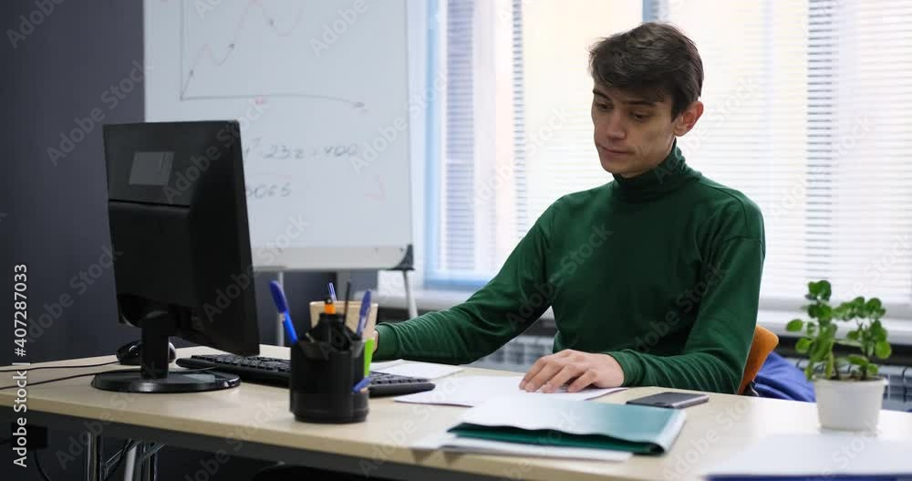 Sad, Tired Businessman Sitting By Desk In Office Sad, Tired Businessman Sitting By Desk In Office