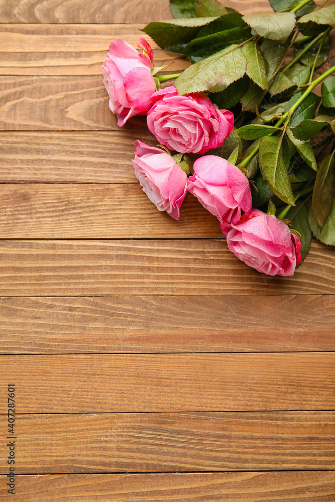 Beautiful pink roses on wooden background Beautiful pink roses on wooden background