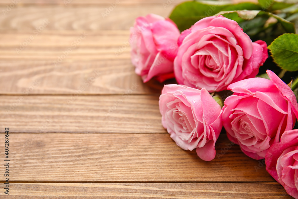 Beautiful pink roses on wooden background Beautiful pink roses on wooden background