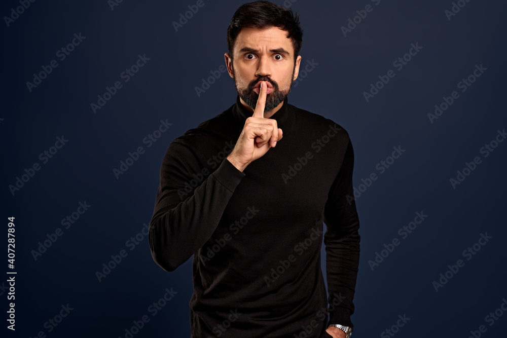 Pissed and angry serious-looking young man hate disobedience and nasty people, shushing, press index fingers to lips with hush silence gesture, standing Blue background displeased, frowning upset Pissed and angry serious-looking young man hate disobedience and nasty people, shushing, press index fingers to lips with hush silence gesture, standing Blue background displeased, frowning upset