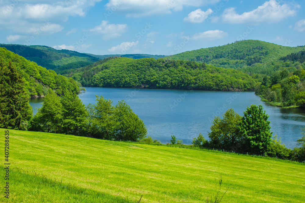 Rursee at Eifel National Park, Germany. Scenic view of lake Rursee and surrounded green hills in North Rhine-Westphalia